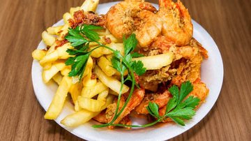 Imagem de camarões a batatas fritas servidas em um prato