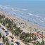 A imagem mostra uma vista aérea da orla da Praia do Centro em Peruíbe, localizada no litoral do Estado de São Paulo