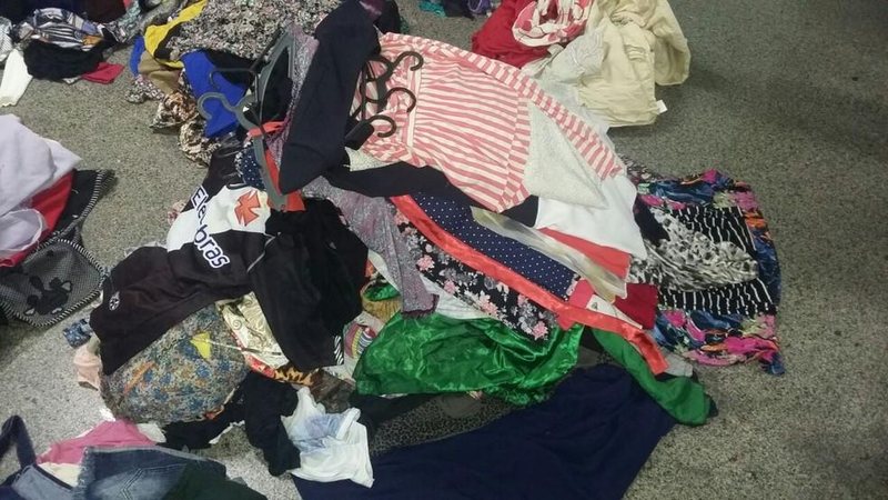 Homens invadiram o local pelo telhado Loja de roupas é assaltada e ladrões levam 50 peças Várias roupas no chão - Divulgação