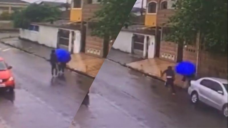 Imagens de câmeras de segurança Homem assalta mulher e leva 'guarda-chuvada' em Guarujá Imagem de câmera de segurança: homem abordando mulher - Reprodução