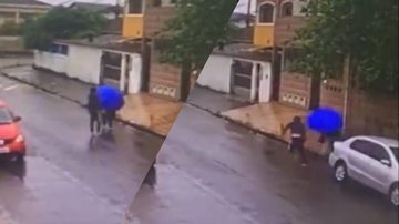Imagens de câmeras de segurança Homem assalta mulher e leva 'guarda-chuvada' em Guarujá Imagem de câmera de segurança: homem abordando mulher - Reprodução