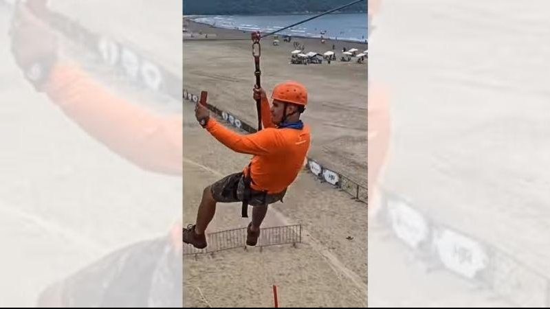 Praias da cidade estão repletas de opções esportivas e culturais Tirolesa e outras atrações agitam Praia Grande Homem em tirolesa na Praia Grande - Reprodução Instagram