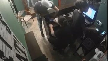 Indivíduos renderam duas funcionárias que estavam no caixa do estabelecimento, e na sequência trancaram os demais trabalhadores no toalete Criminosos armados rendem funcionários de um restaurante no Guarujá e roubam o local Criminoso rendendo as funcionári - Reprodução