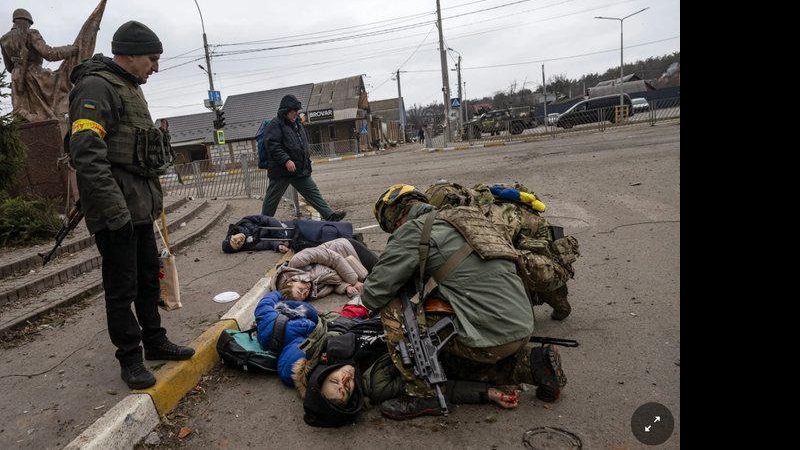 Soldados ucranianos tentam salvar o pai da família atingida pelo morteiro Vídeo mostra momento em que civis são mortos por morteiros russos - Lynsey Addario/The New York Times