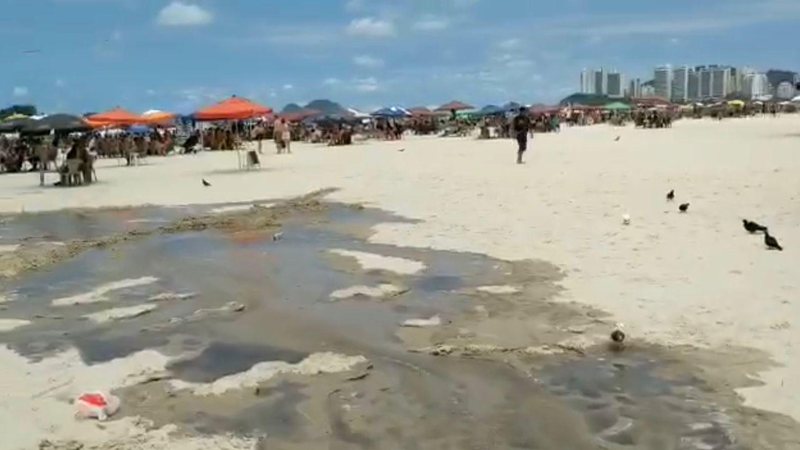Agentes da prefeitura foram até o local e identificaram um forte odor Vazamento de esgoto na praia de pitangueiras, Guarujá Esgoto escorrendo na areia da Praia de Pitangueiras, ao lado de pessoas que estavam embaixo do guarda sol - Divulgação/Prefeitura de Guarujá