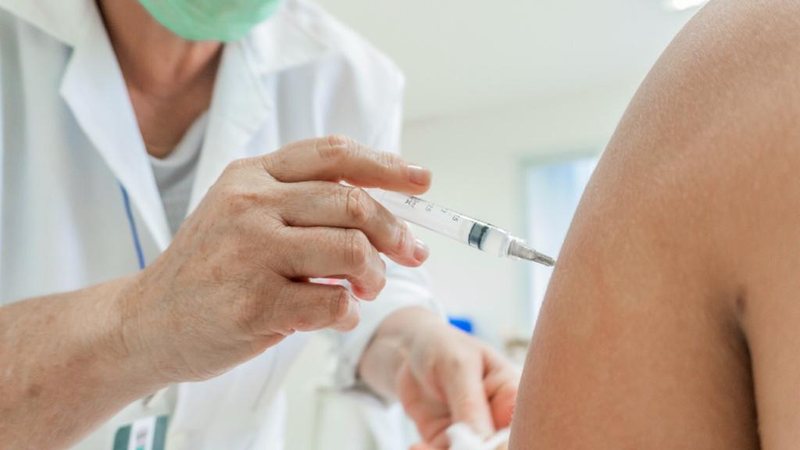 Vacinação está disponível na cidade Moradores de Praia Grande podem se vacinar neste domingo Profissional da saúde aplicando vacina em outra pessoa - Imagem: Divulgação