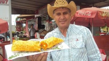 Estabelecimento comercial fica na avenida 19 de Maio, em Bertioga (SP); pastel tem praticamente 30 centímetros Donizete do Pastel do Trevo Donizete dono do Pastel do Trevo com um pastel de 30 centímetros na mão - Reprodução
