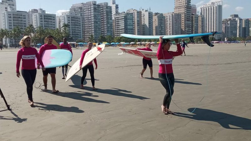 Aula inaugural da escola, neste sábado Escola de surf só para mulheres é inaugurada em Santos Mulheres na areia de praia com pranchas de surfe - Imagem: Divulgação / Blue Med Bellas