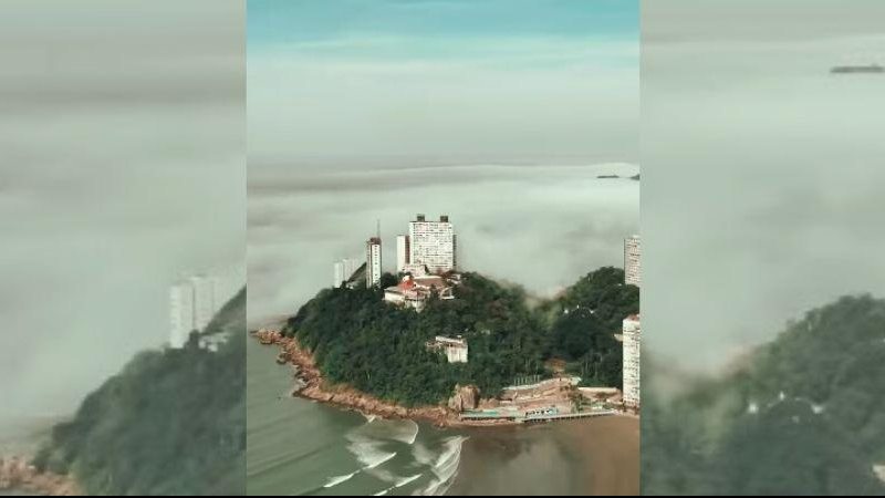 IOrla vicentina foi tomada pelo cobertor de nuvens na manhã desta sexta-feira (15) Drone capta neblina que cobriu cidades da Baixada Santista nesta sexta (15) Ilha Porchat, em São Vicente, sendo encoberta por neblina - Reprodução/Instagram @drone.rrv
