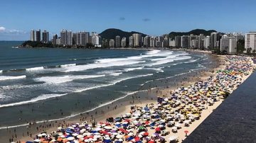 Praia de Pitangueiras durante temporada de verão Guarujá Vista aérea de praia lotada - Imagem: Arquivo / Vladmir Maria