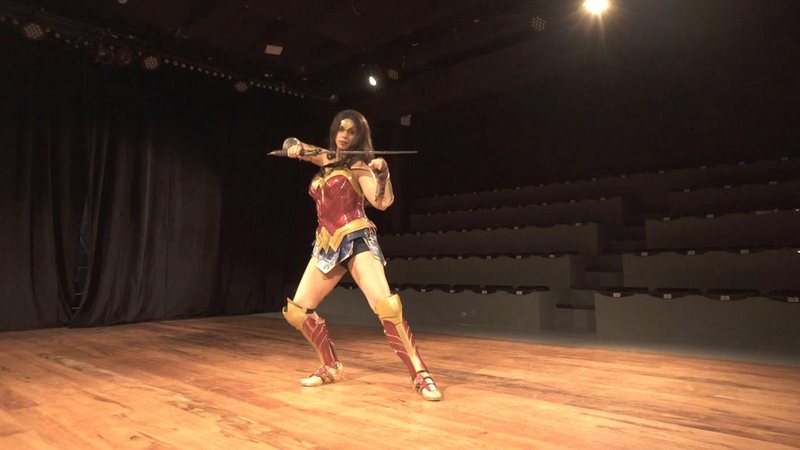 Kelly Rodrigues dá vida a personagem Mulher-Maravilha Cosplayers prometem ser um dos pontos altos do Festval Geek de Santos Cosplayer Kelly Rodrigues vestida de mulher-Maravilha em palco - Divulgação/Prefeitura de Santos