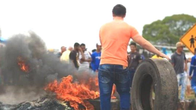 Intenção do movimento é apenas retirar os materiais que bloqueiam as estradas e não entrar em confronto com os manifestantes Movimento dos Sem Teto promete enviar integrantes para desbloquear estradas Manifestante empurra pneu em direção à barricada de fog - Reprodução/Felicciano/Metrópoles