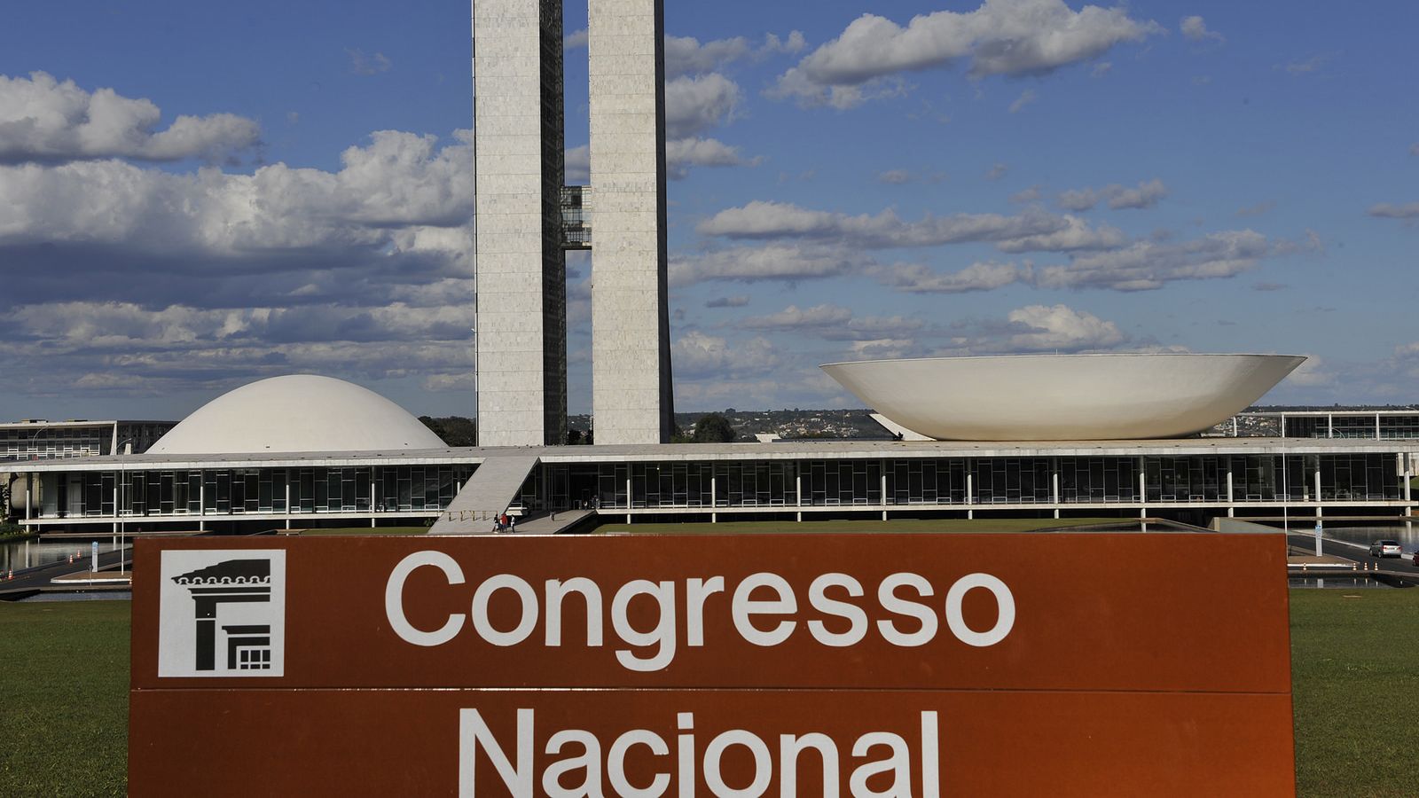 Imagem do Congresso Nacional com céu azul e algumas nuvens no horizonte